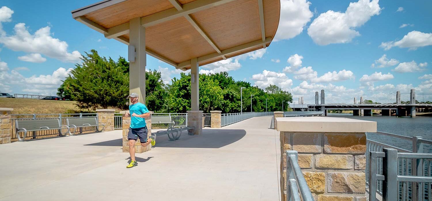 man running on Waco Riverwalk trail